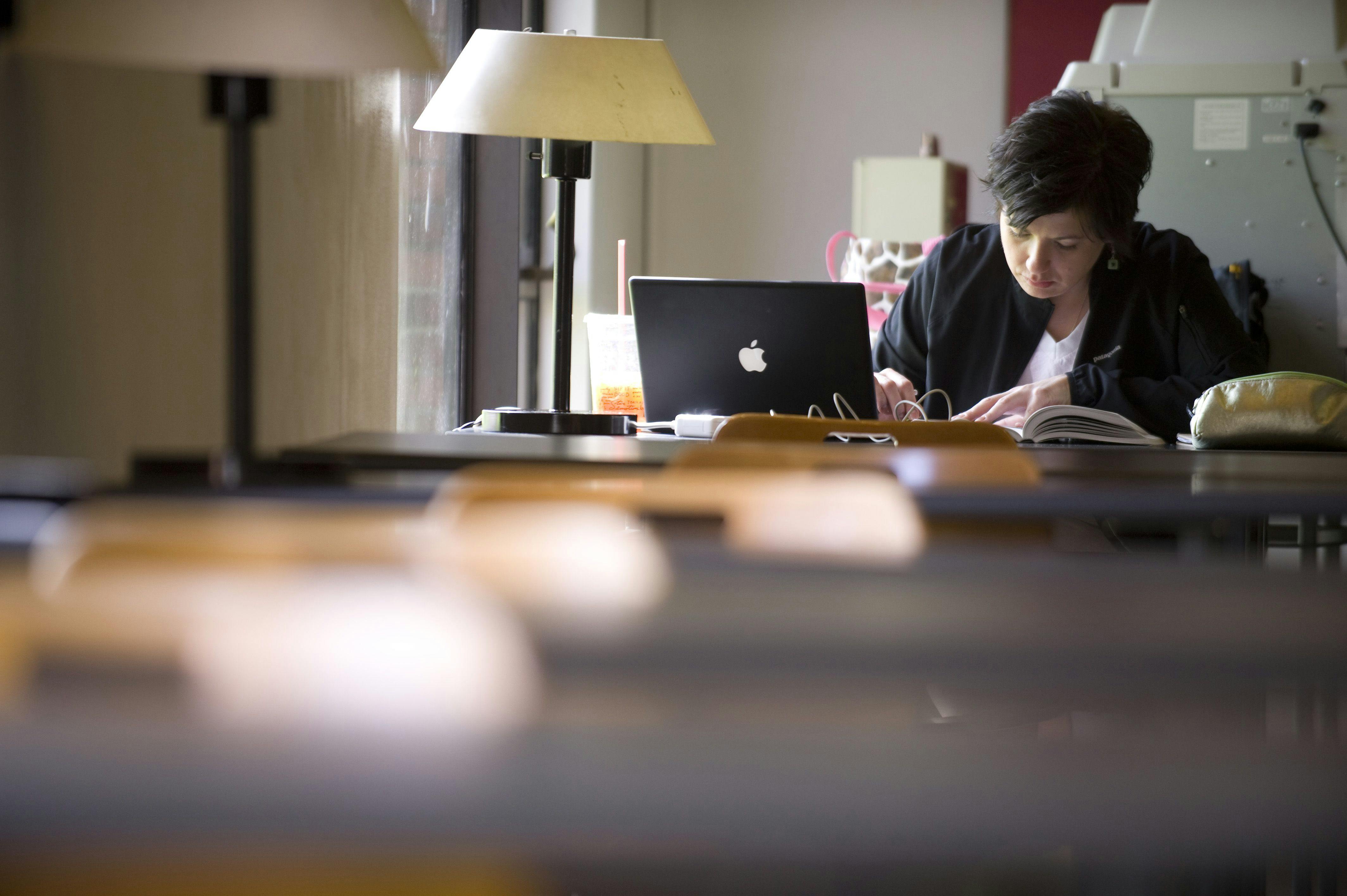 A seminary student works on her computer.