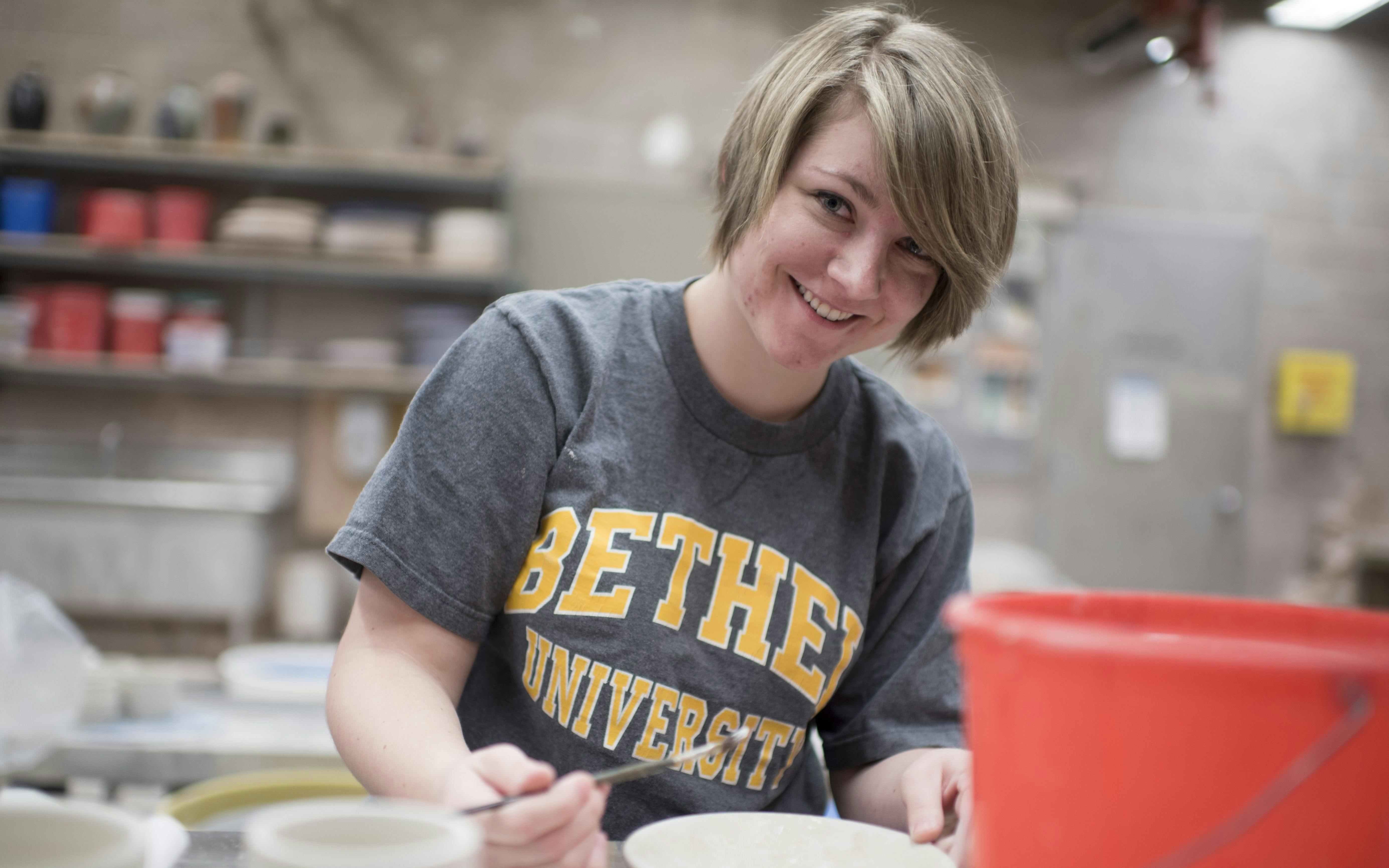 A student works on pottery.