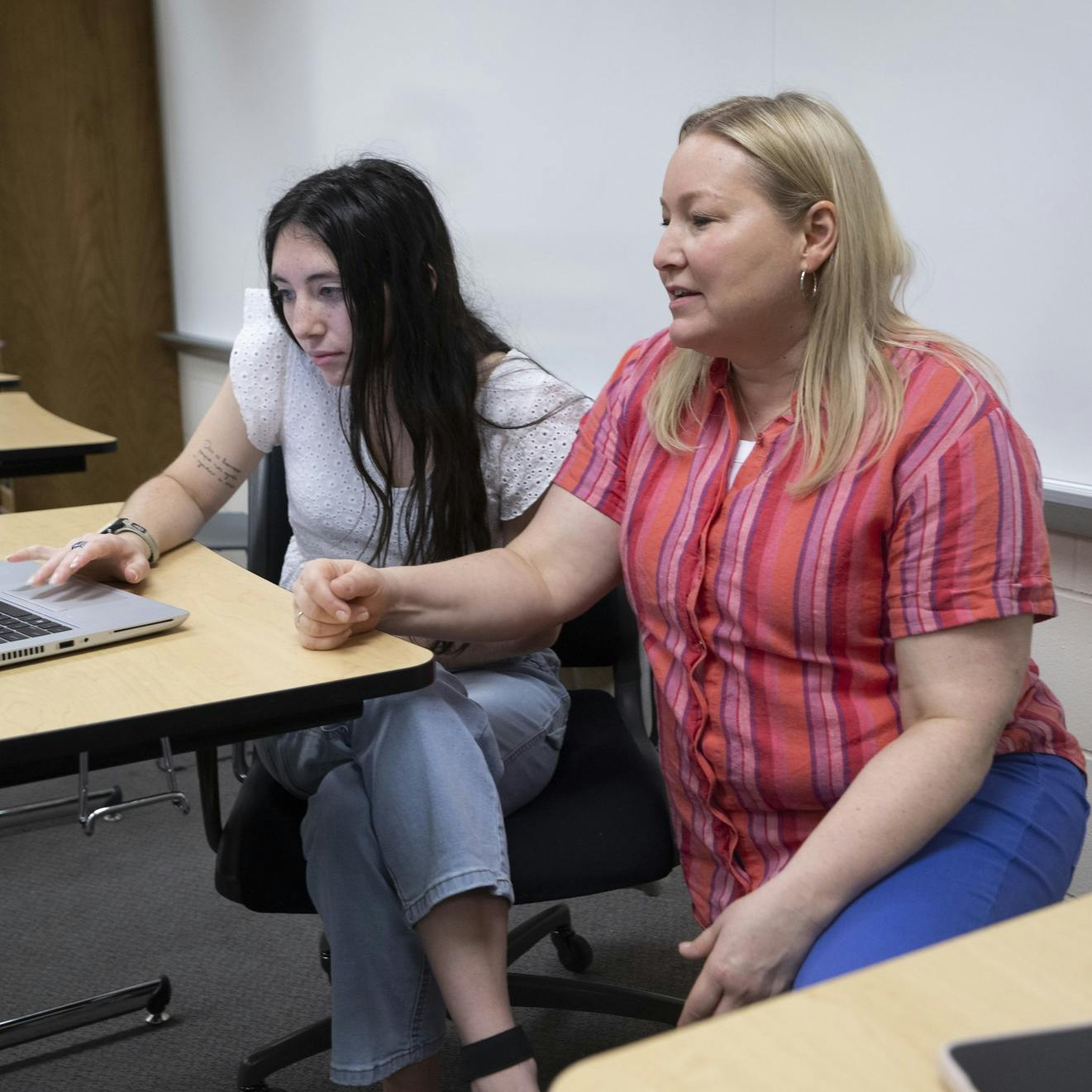 A student interacts with a professor