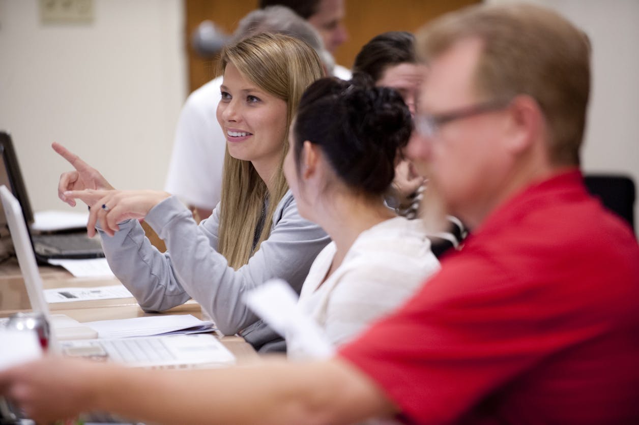 Adult undergrad students have a class discussion.