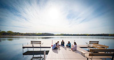 Students conversing on Lake Valentine dock