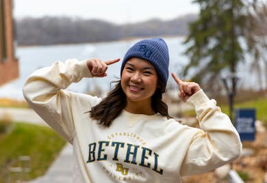 Smiling student wearing Bethel University beanie