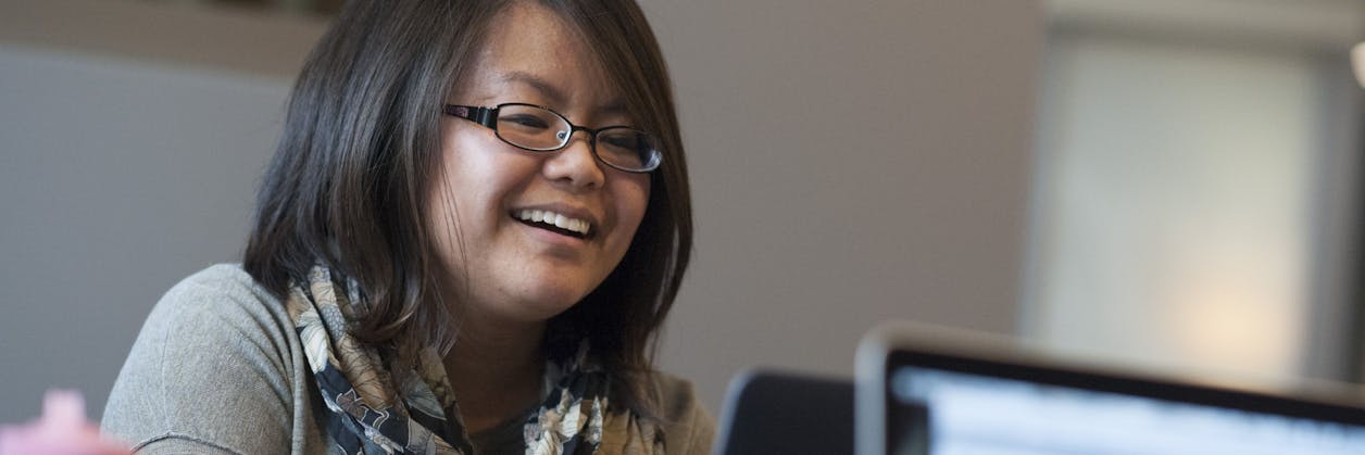 Adult undergrad student studies on computer.