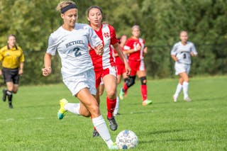 Bethel soccer player kicks the ball