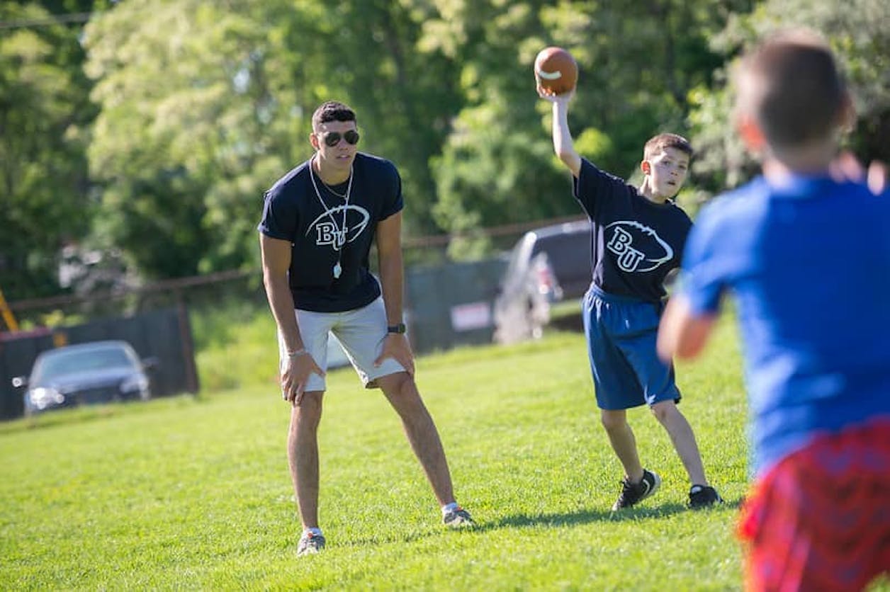 camper throwing football