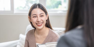 A counselor listens intently to the person seated across from them.