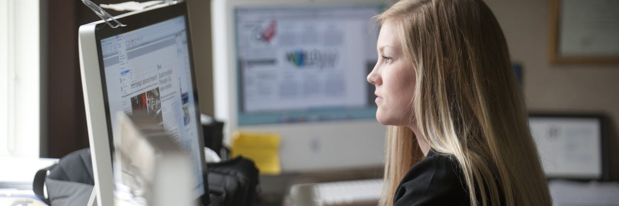 Graduate student studying on computer.