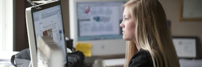 Graduate student studying on computer.