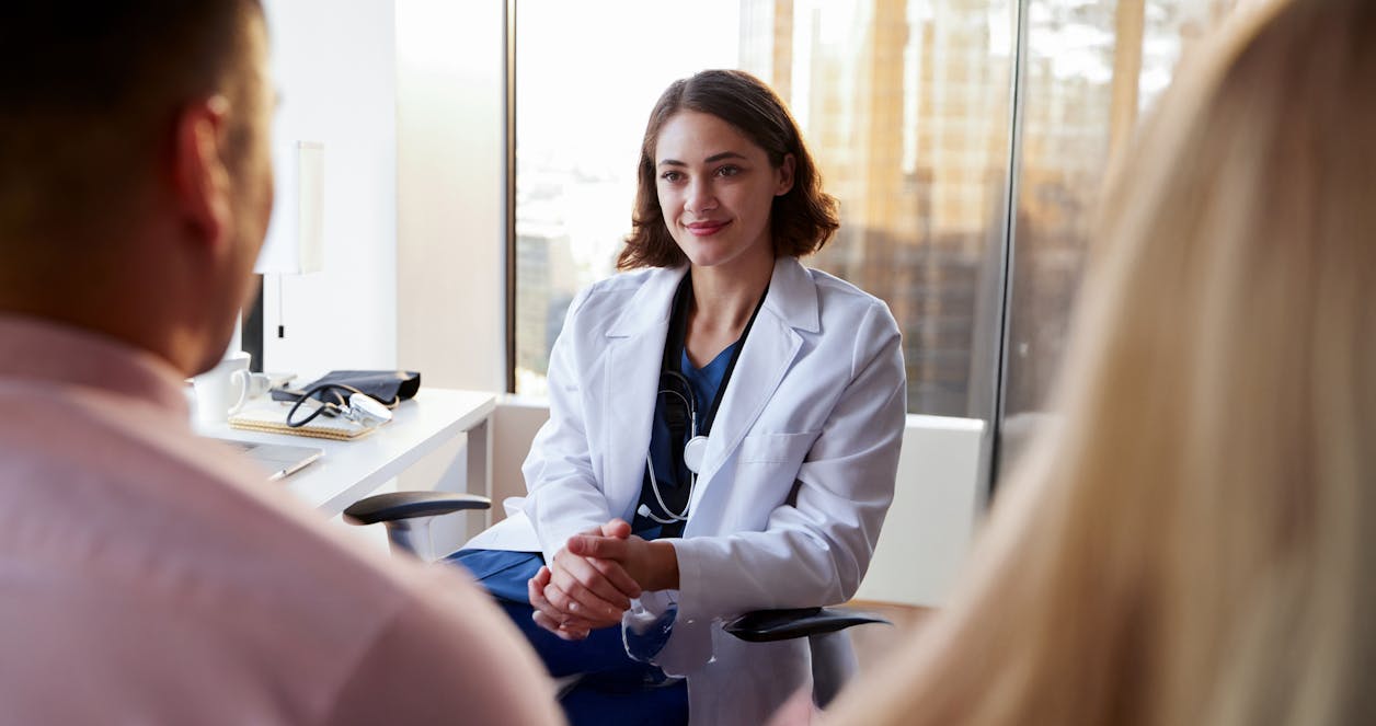 Physician assistant in office meeting with patients