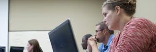 Students work at computers during class.