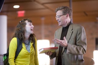 A Bethel student interacts with a professor between classes. 