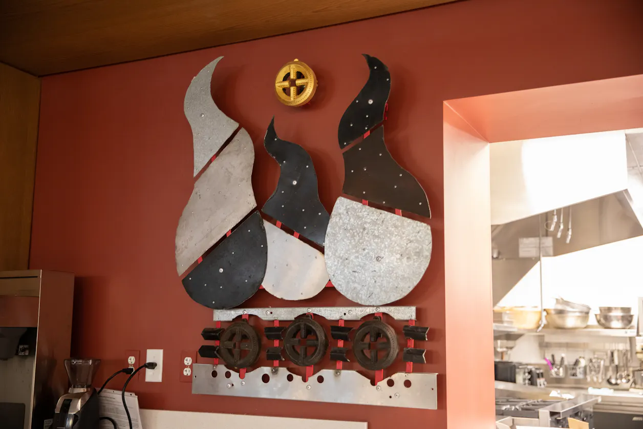 “Add Fire to the Flames” is a nod to fire, which reflects passion and has played a key role in storytelling throughout human history. The piece was dedicated to Rosa Uy and Karen Pfeifle, long-time church members who have prepared and served hundreds of meals on the church’s enormous, six-burner stove. 