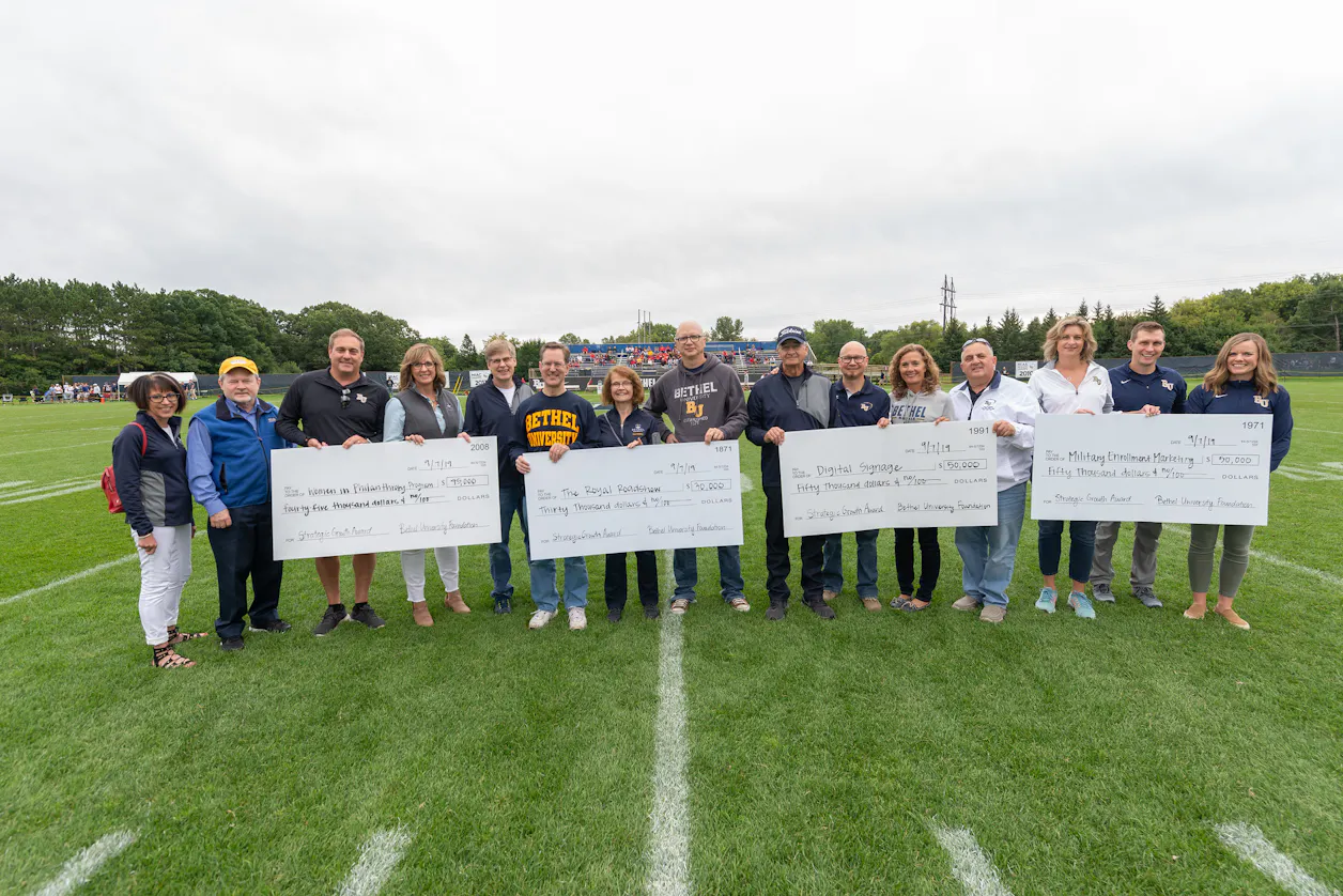 Proponents of the four winning proposals received checks for their groups before the September 7 football game.