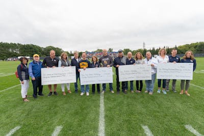 Proponents of the four winning proposals received checks for their groups before the September 7 football game.