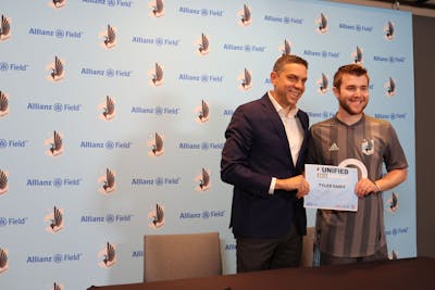 BUILD student Tyler Sarff stands next to Manny Lagos, Sporting Director of the Minnesota United FC (Photo courtesy of Special Olympics Minnesota)