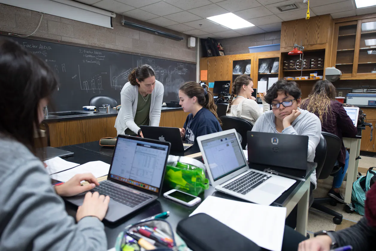 Professor of Biology Sara Wyse works with students in a science classroom at Bethel University.
