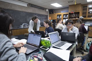 Professor of Biology Sara Wyse works with students in a science classroom at Bethel University.
