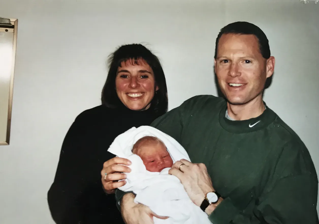 Family friends Alea and Dan Dye hold Anna Hage on the day she was born in 1999. 