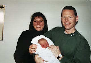 Family friends Alea and Dan Dye hold Anna Hage on the day she was born in 1999. 