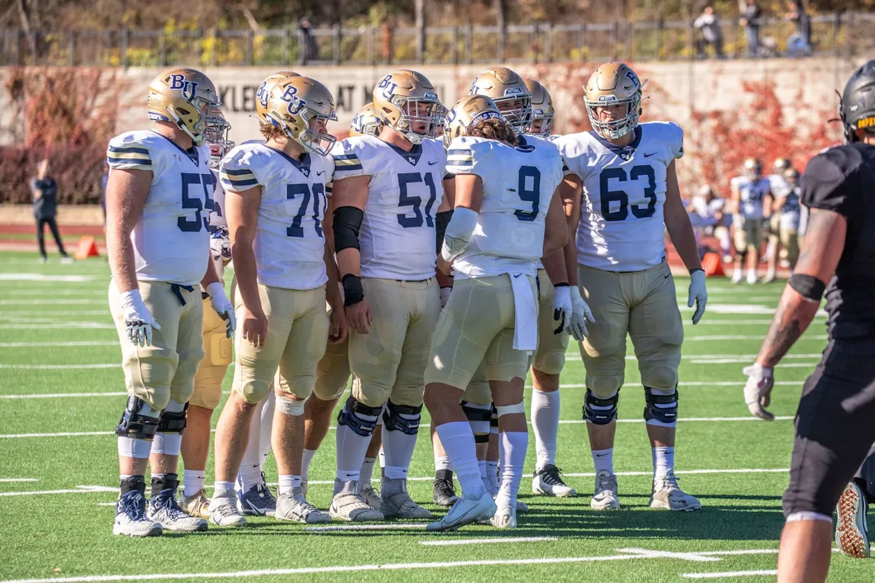 Roste (#9) connects with his team before the next play.