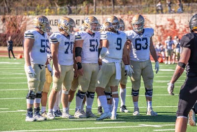 Roste (#9) connects with his team before the next play.