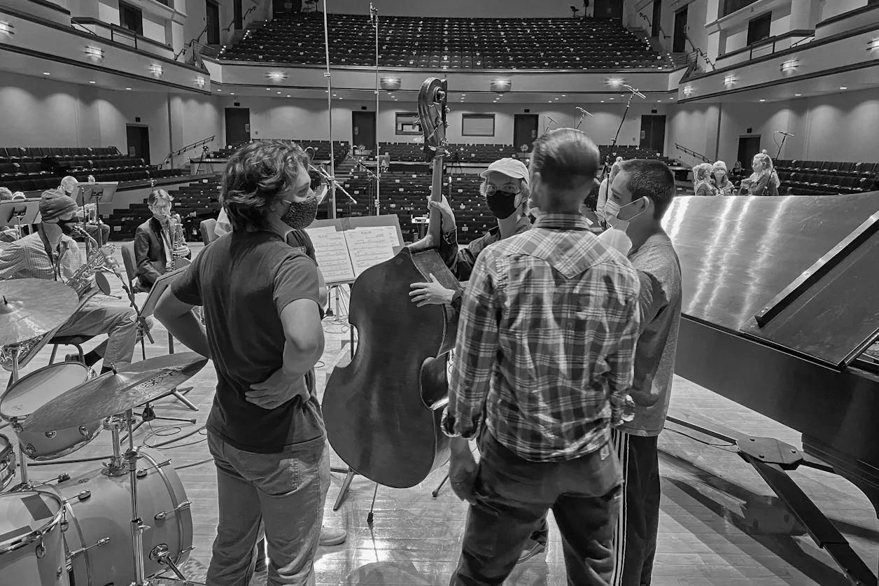 Professor of Music Jason Harms led student musicians through the recording process in Benson Great Hall last December.