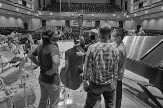 Professor of Music Jason Harms led student musicians through the recording process in Benson Great Hall last December.