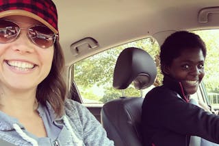 Image of Rachel Hanus in a car with an ESTHER Homes mom practicing driving