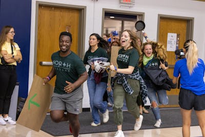Students from North Village residence halls entering Robertson Center Gym on Cheer Night