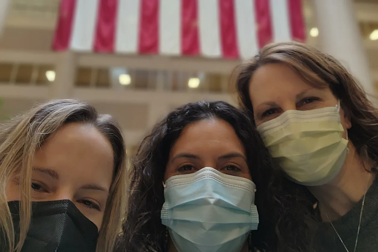 Kristen Kirk CAPS'22 (right) with two fellow post-baccalaureate nursing graduates on their first day as employees at the VA.