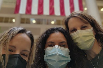 Kristen Kirk CAPS'22 (right) with two fellow post-baccalaureate nursing graduates on their first day as employees at the VA.