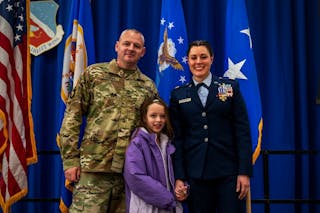 Maj. Lunning is all smiles with her husband and daughter after receiving her award.