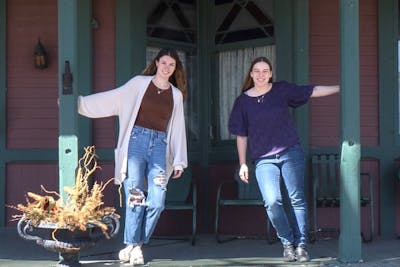 Emily Roeck ’23 and Brianna Mutterer ’24 pose outside the Fillebrown House in White Bear Lake, Minnesota. Through a new partnership, Roeck and Mutterer are the first two Bethel students to intern at the White Bear Lake Area Historical Society.