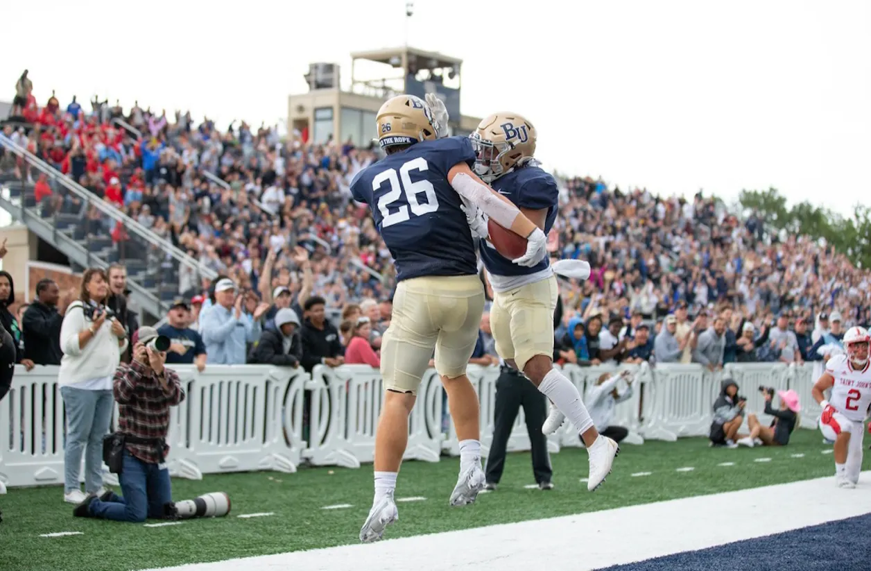 Aaron Ellingson celebrates with a teammate after a touchdown at Royal Stadium