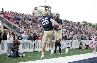 Aaron Ellingson celebrates with a teammate after a touchdown at Royal Stadium