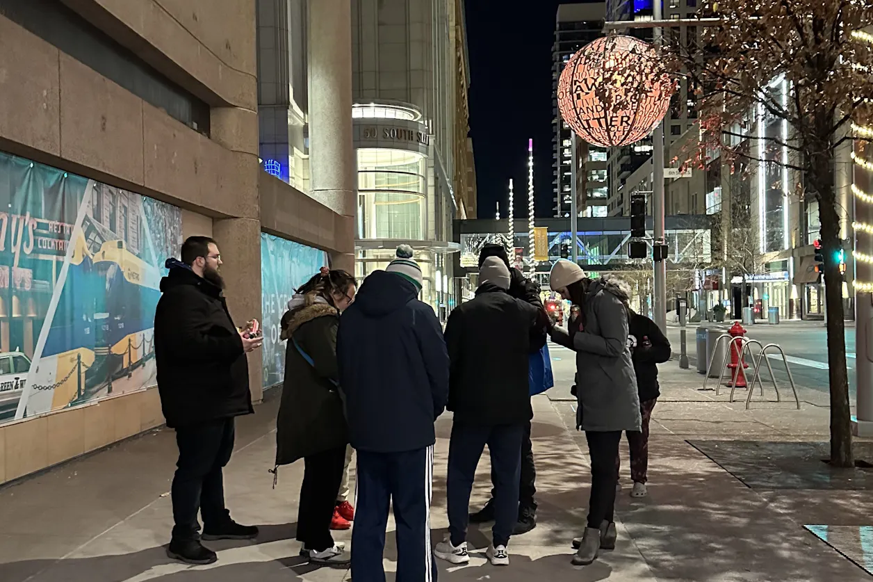 Bethel students and ICCM volunteers pray over people on Nicollet Avenue in downtown Minneapolis.