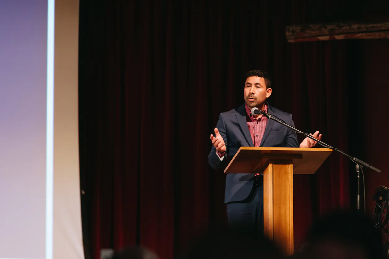Alex Perla Castillo on stage sharing his story at the Scholarship CElebratoin