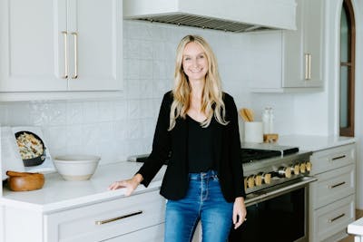 Alisa Sparks '08, founder and CEO of Linden Creek, poses in a kitchen during a house staging photoshoot.