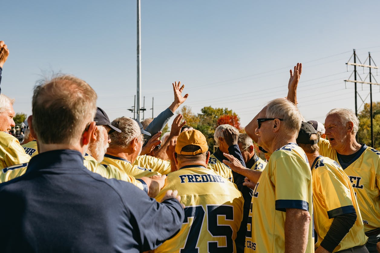 Bethel football alumni gather on-field during Homecoming
