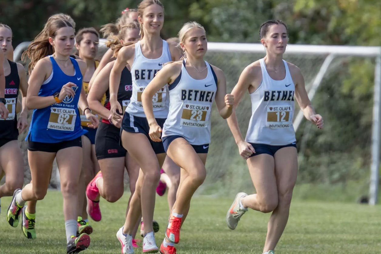 Women’s cross country team running together at the St. Olaf Invitational.