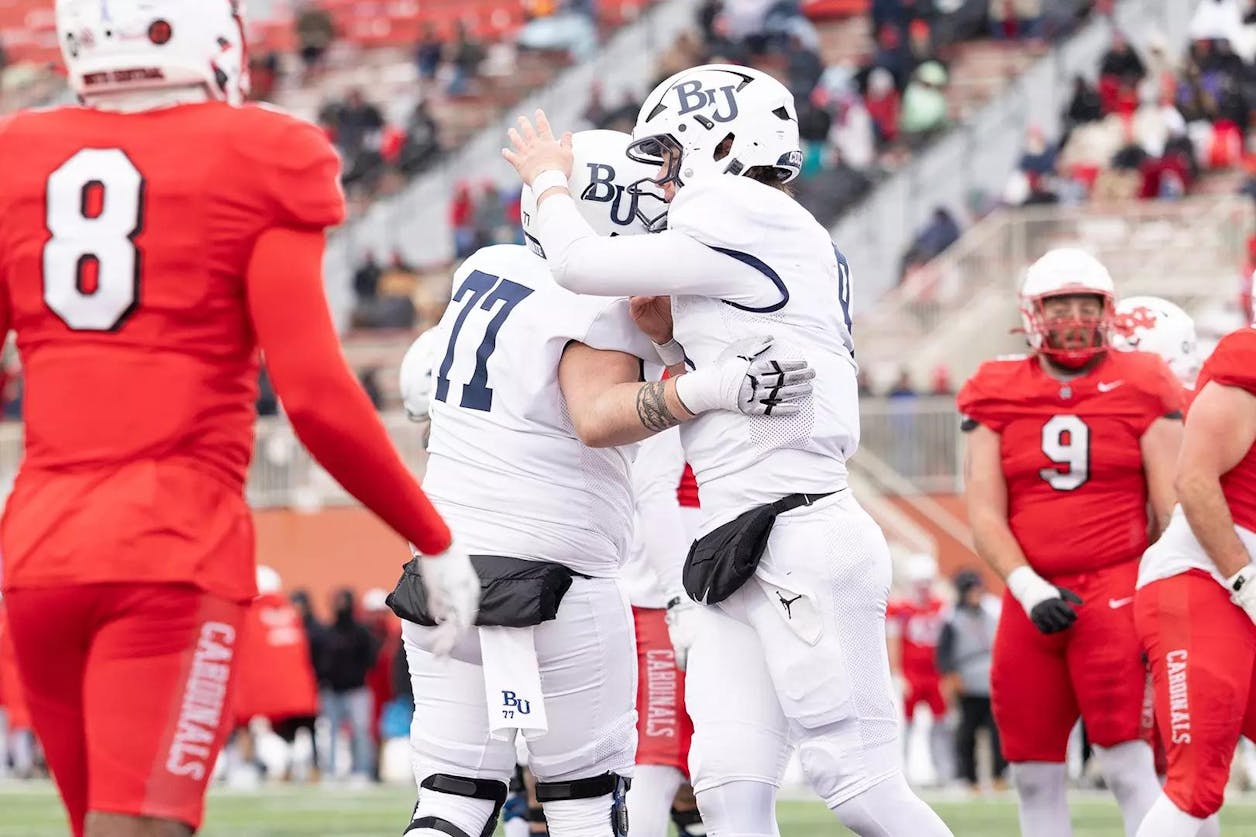 Bethel football players celebrate on the field during a game against the Cardinals. 