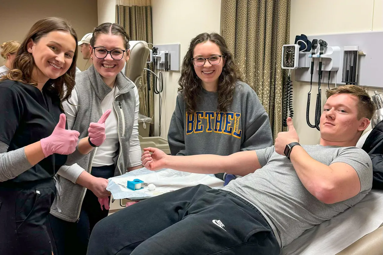 graduate students draw blood for undergrad students' research project