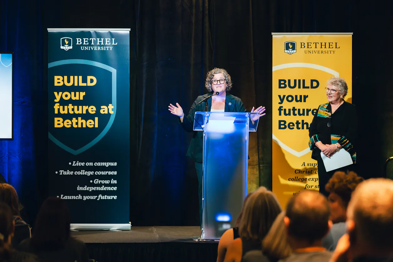 A speaker presents on stage during the BUILDing the Future: 10 Years of Impact event at Bethel.