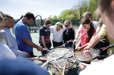Physical education professor Dottie Haugen GS'93 prayed with her students. 