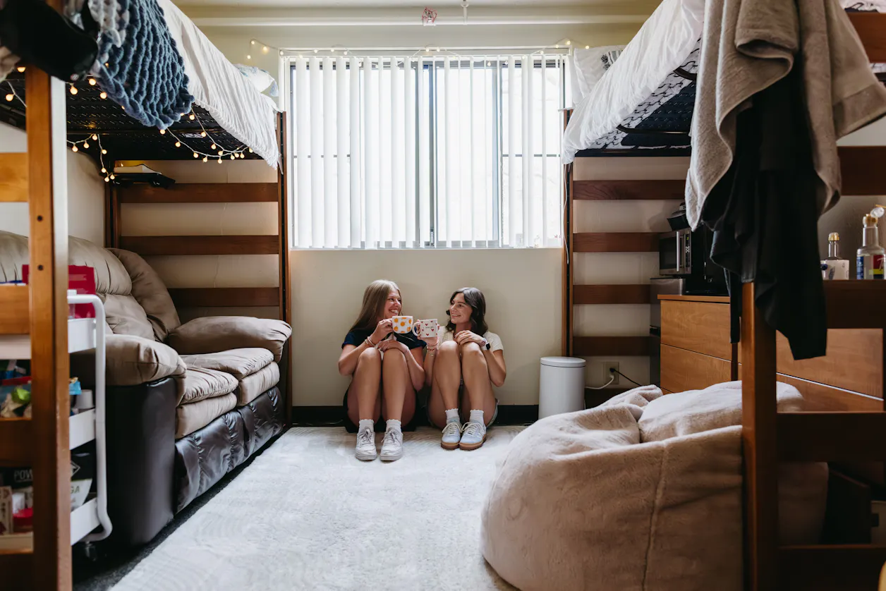 Roommates sip coffee in their dorm room in Edgren Hall