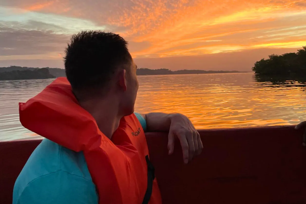 PA student Nate Chau on a boat at sunset on his rotation in Panama