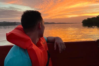 PA student Nate Chau on a boat at sunset on his rotation in Panama