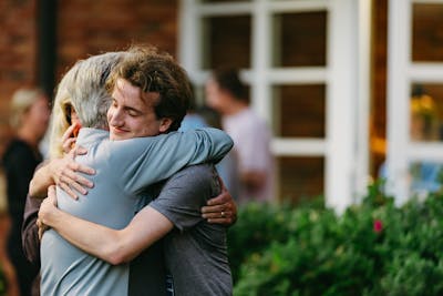 First-year student Nick Rudeen hugged his parents during Welcome Week 2025. 