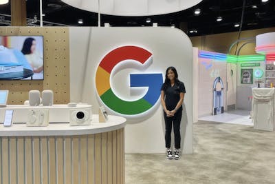 Sarah Peterson at a Best Buy vendor event next to a Google marketing booth she created as part of her role in partner marketing.