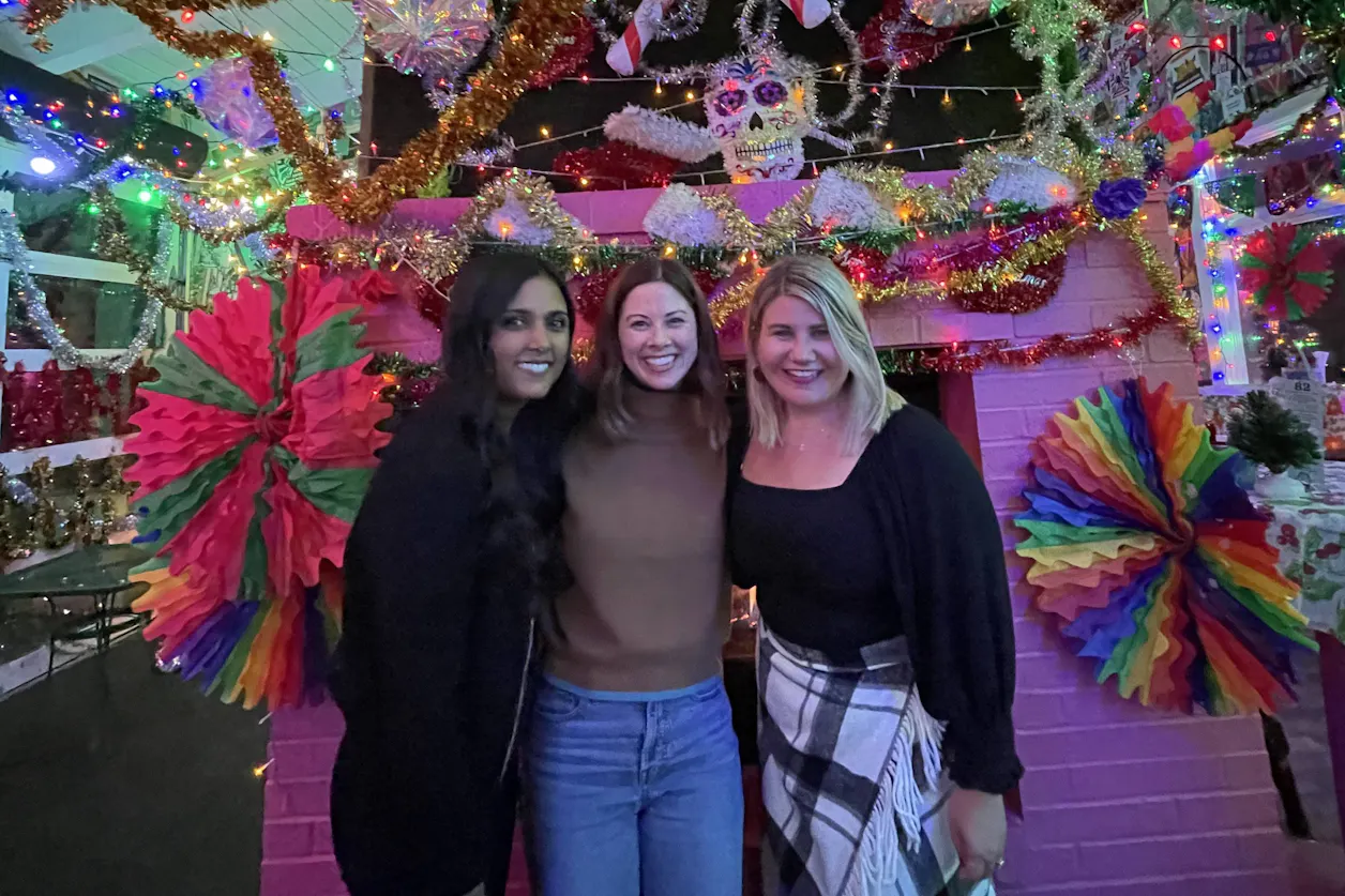 Sarah Peterson with Bethel University alumnae Sara Gengler (Romsaas) and Laura Lorentz (Hendrickson), smiling together in a casual group photo after graduation.